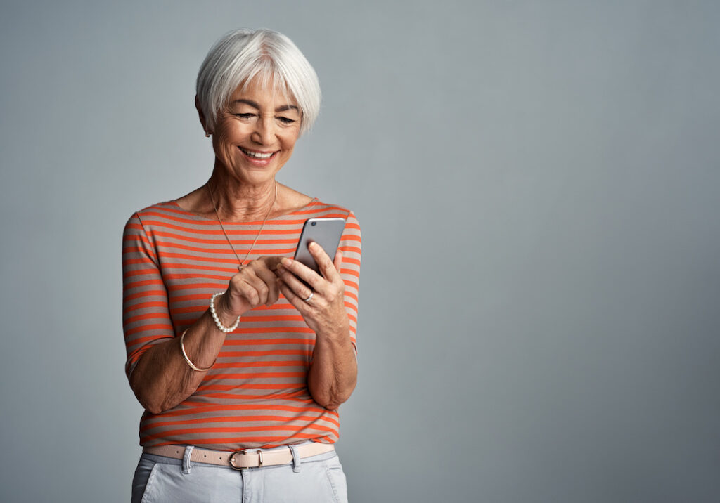 Women delights in the content of her search results on her mobile device.