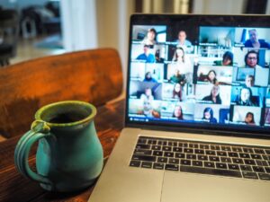 A photo of a laptop with 25 people on a zoom call.